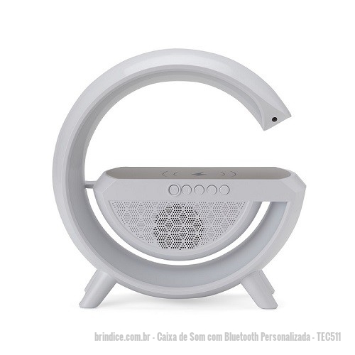 Caixa de Som com Bluetooth personalizada - Caixa de Som com Bluetooth Personalizada - TEC511 - Caixa de som com carregador por indução e luminária. Possui 6 modos de iluminação, opera nos modos bluetooth, rádio FM, auxiliar P2, USB e TF (cartão MicroSD). Para desfrutar do carregamento por indução (sem fio) é fundamental que o celular possua a tecnologia QI, o produto só armazena bateria para funcionamento próprio, para funcionar a indução precisa estar conectado a uma fonte de energia. - 170231 - Portal de Brindes Personalizados | Guia Bríndice 38 Anos - Caixa de Som com Bluetooth